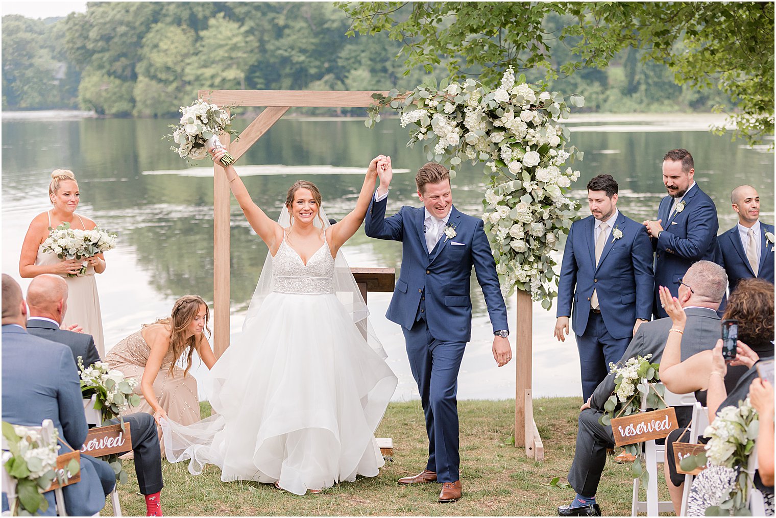 bride and groom cheer leaving outdoor wedding ceremony by water at Indian Trail Club