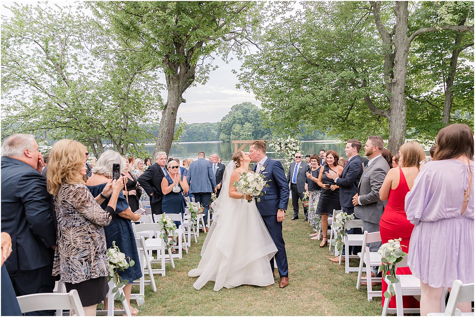 newlyweds kiss in aisle at Indian Trail Club 