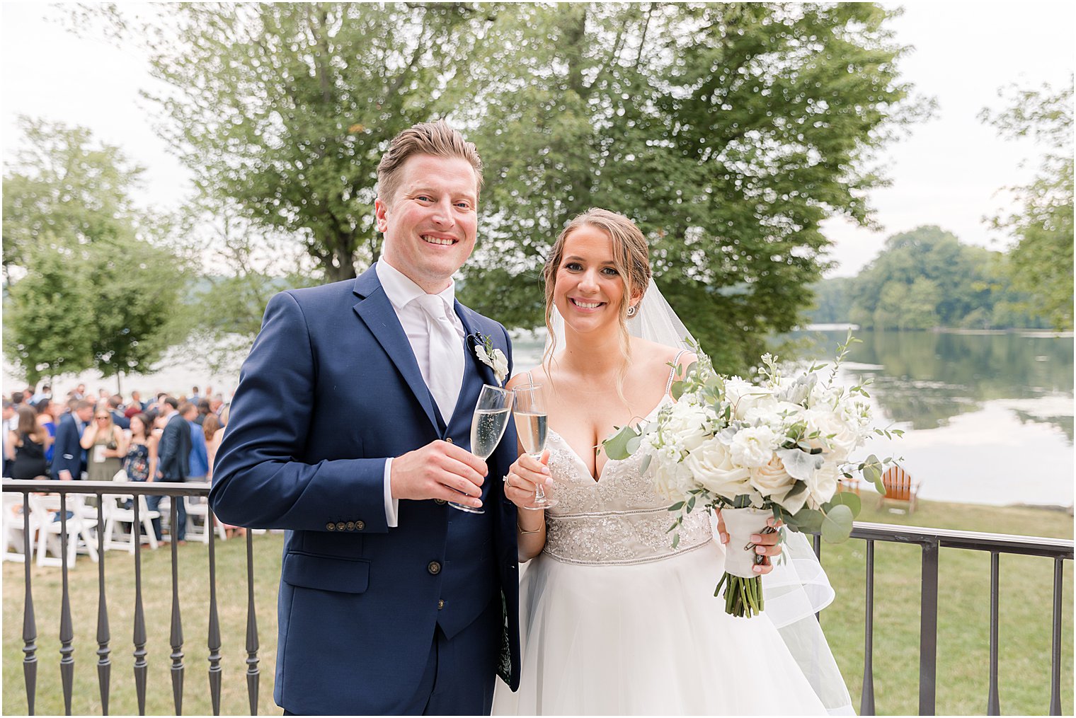 bride and groom stand with signature cocktails