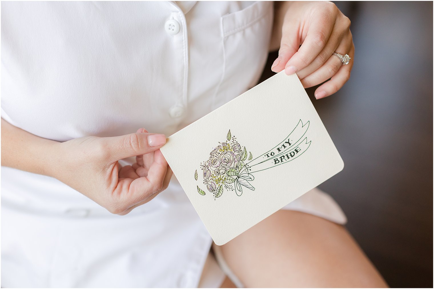 bride holds card on wedding morning at Park Chateau Estate