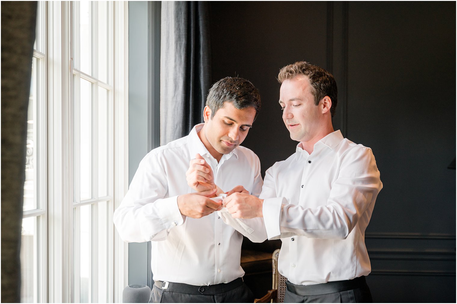 groomsman helps groom with cufflinks in New Jersey 