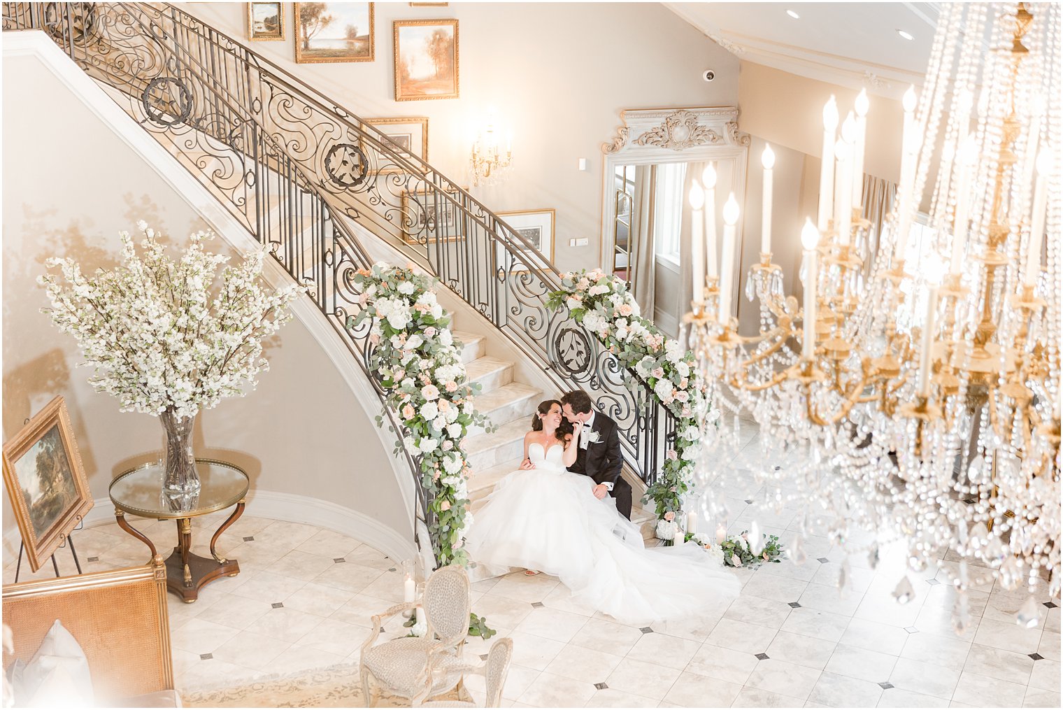 bride and groom sit on staircase at Park Chateau Estate