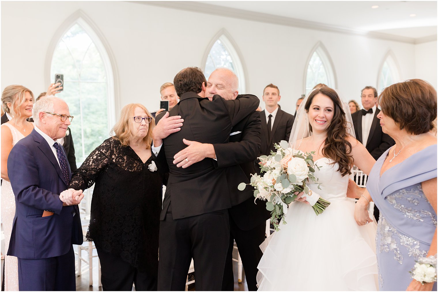 dad hugs groom during ceremony at Park Chateau Estate