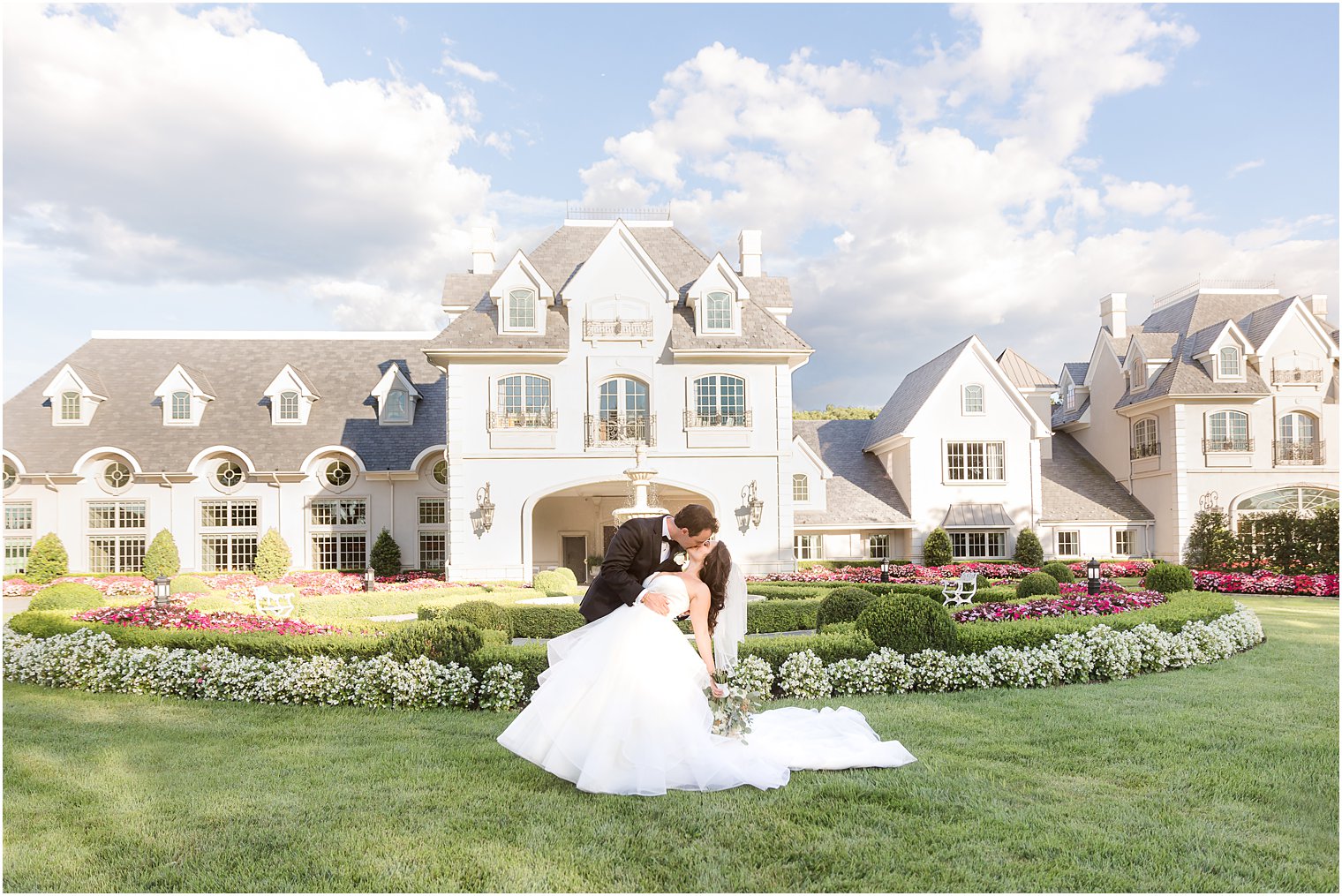 groom dips bride kissing her outside Park Chateau Estate