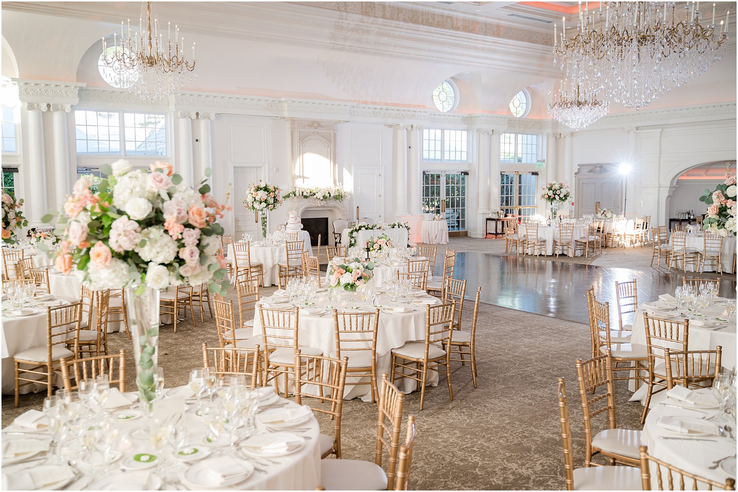ballroom at Park Chateau Estate with pink and white floral centerpieces 