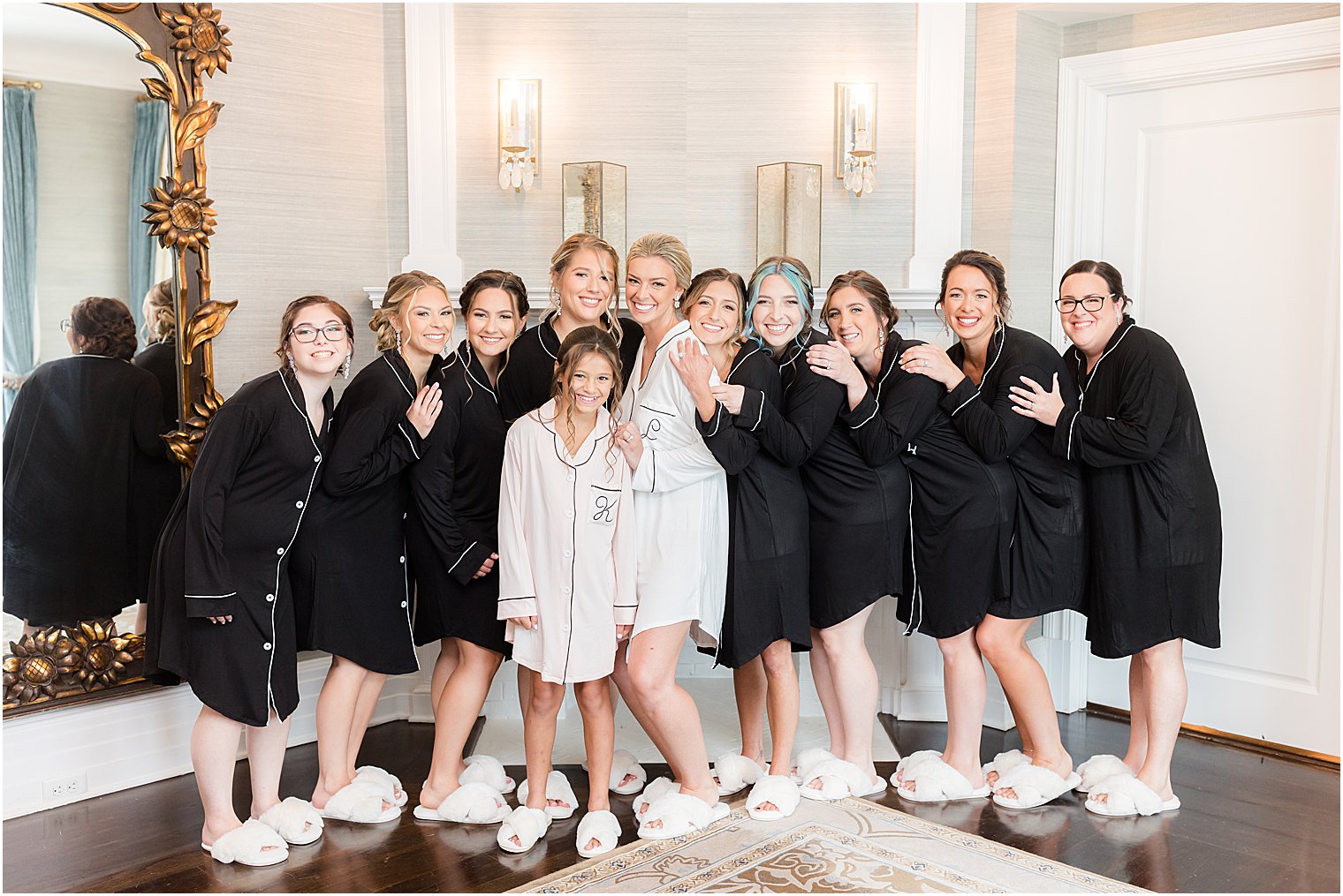 bride poses with bridesmaids in black pajamas