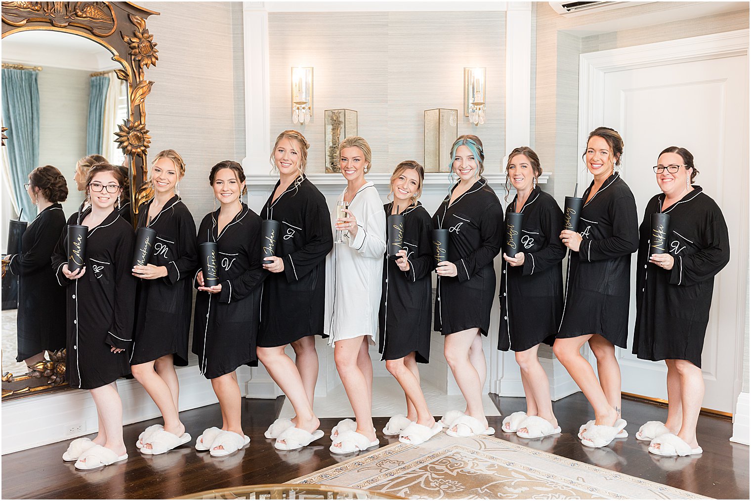 bride and bridesmaids pose in matching robes at Shadowbrook at Shrewsbury