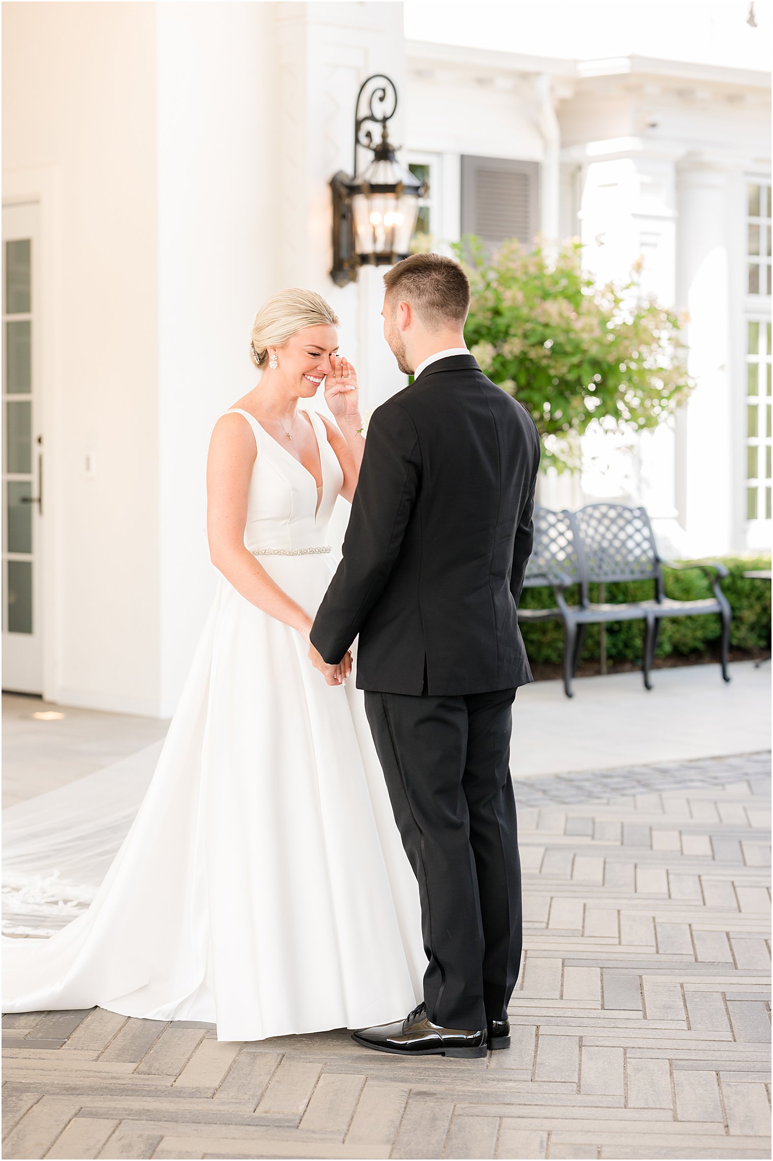 bride cries with groom during first look