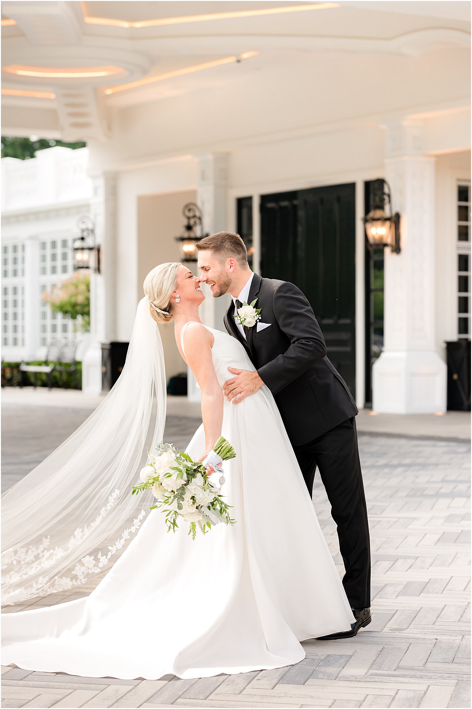 groom dips bride slowly outside Shadowbrook at Shrewsbury