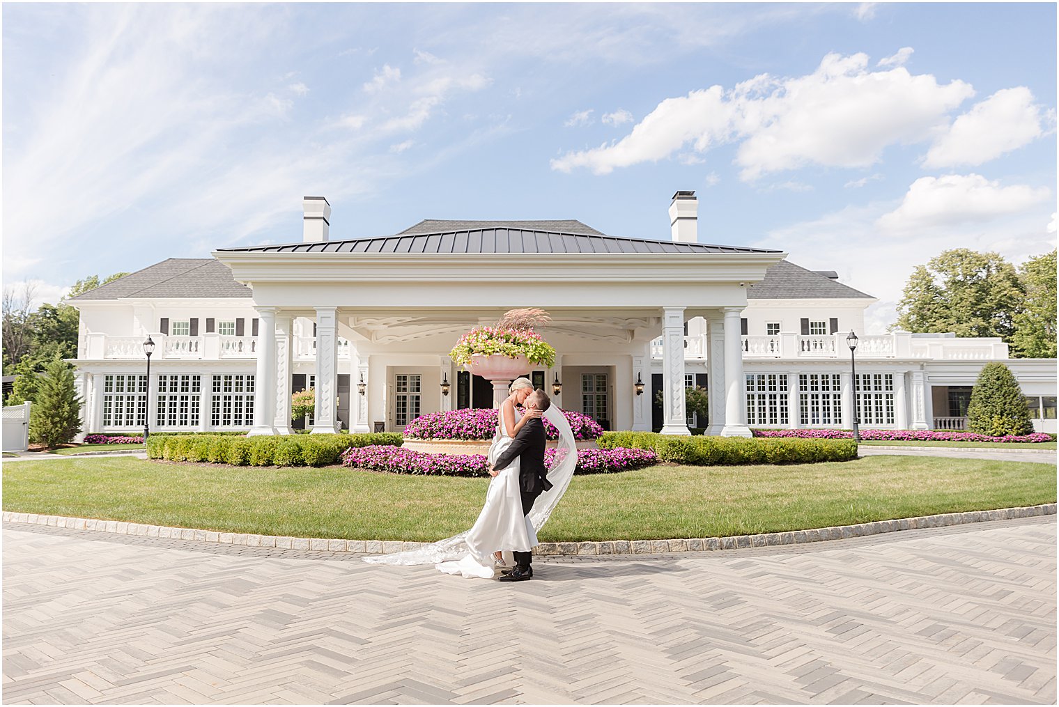 newlyweds kiss outside the fountain at Shadowbrook at Shrewsbury