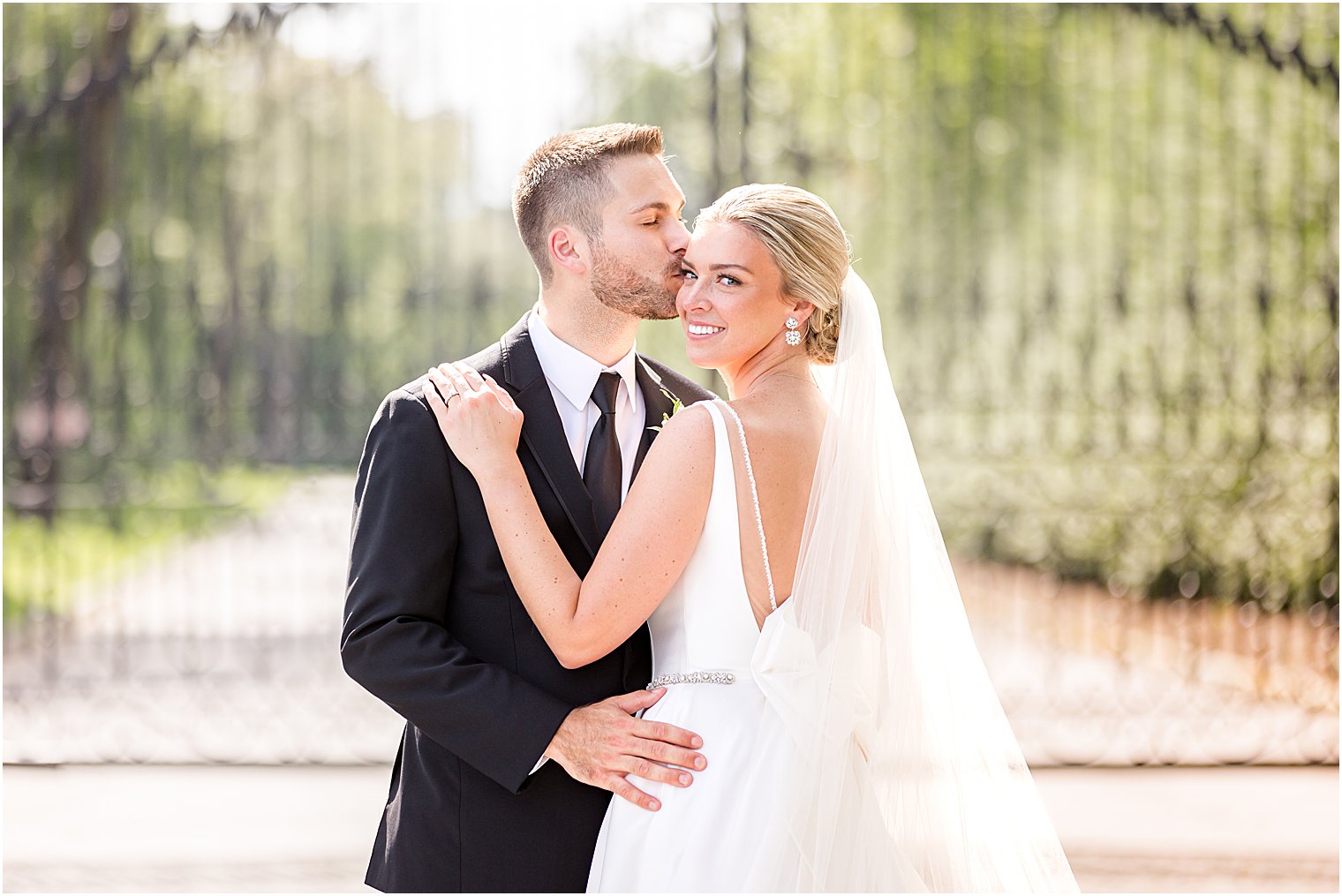 groom kisses bride's forehead at Shadowbrook at Shrewsbury