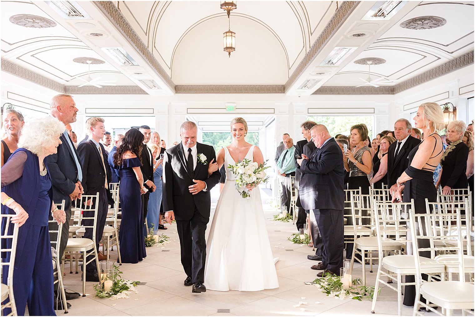 bride walks down aisle at Shadowbrook at Shrewsbury with father