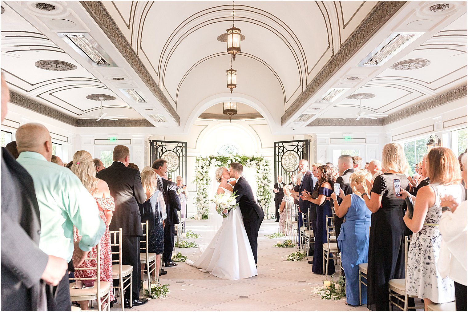 newlyweds kiss during wedding ceremony at Shadowbrook at Shrewsbury