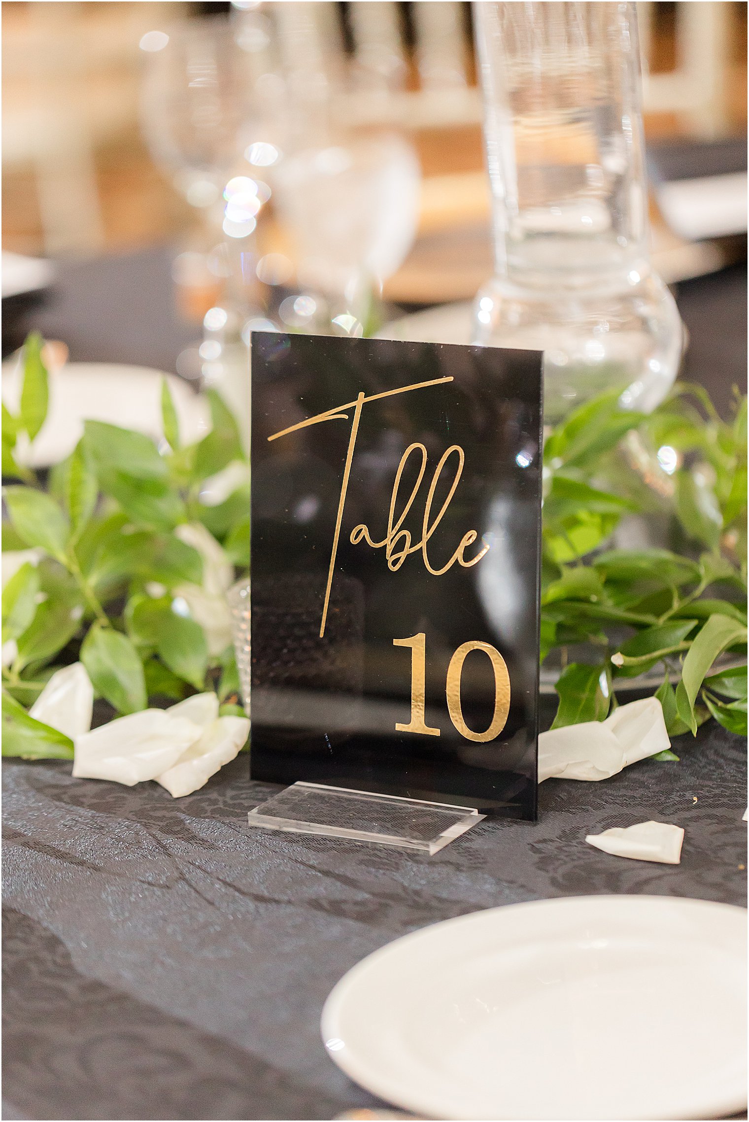 table numbers in black and gold at Shadowbrook at Shrewsbury
