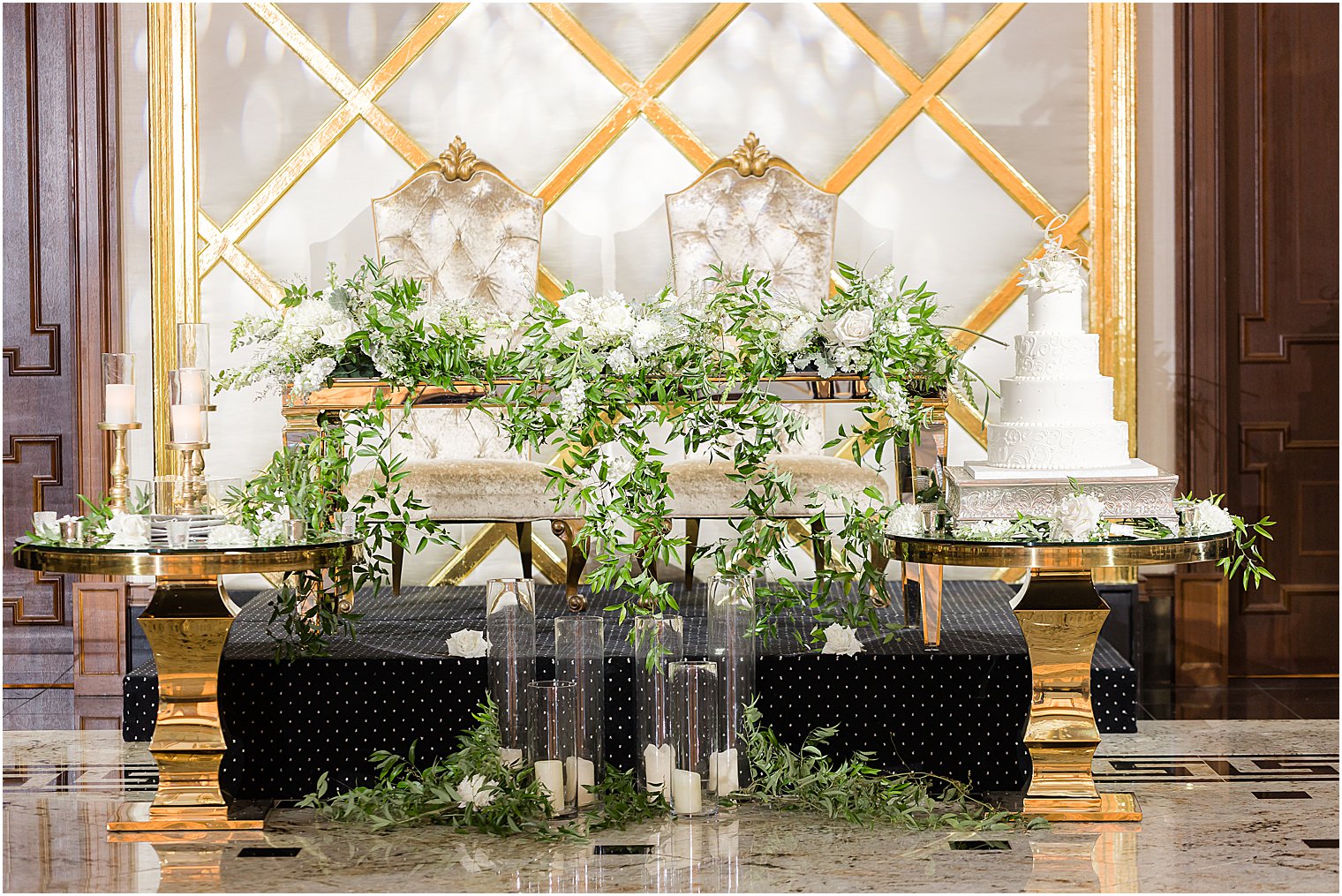 sweetheart table with greenery draped around front