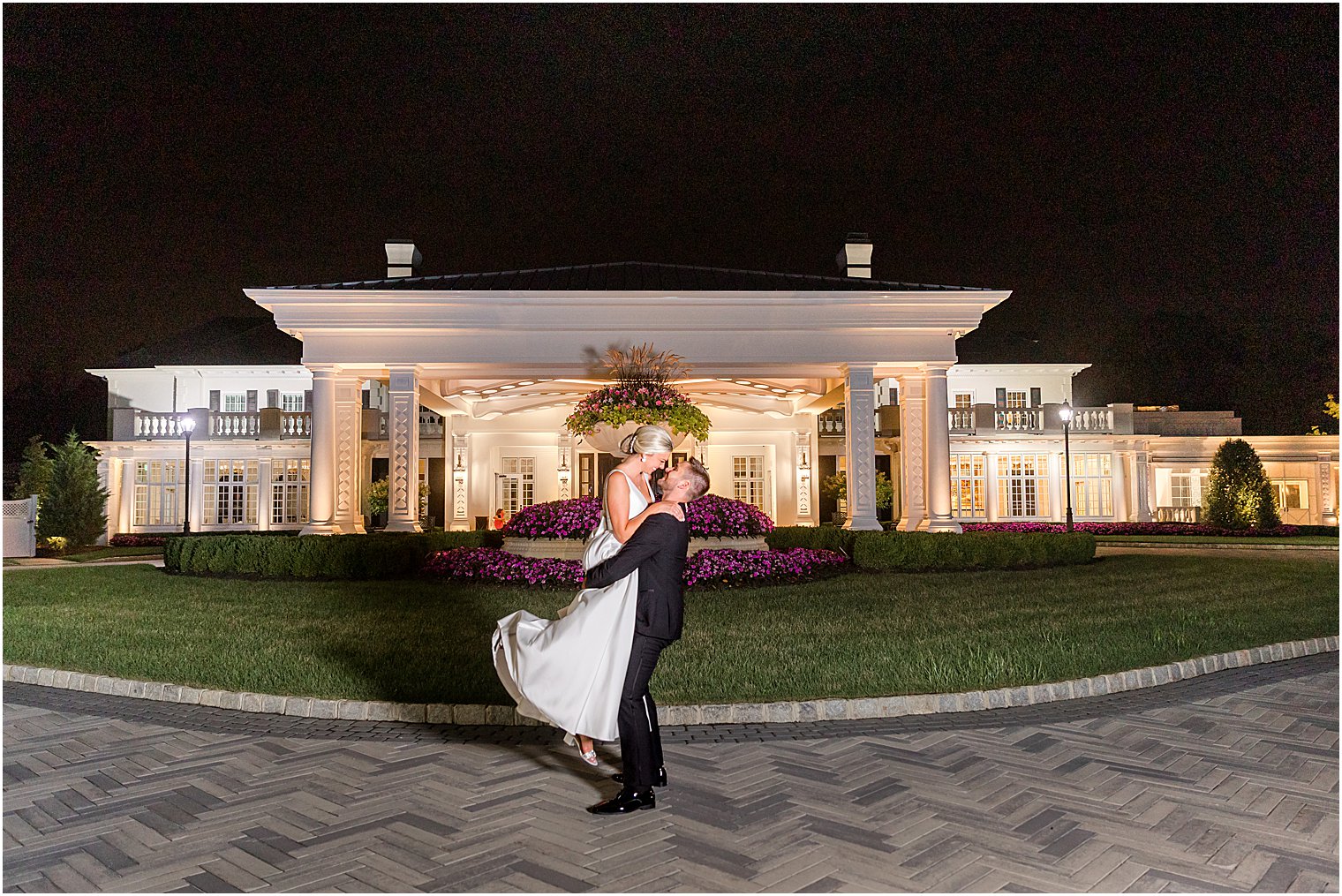 groom lifts bride outside Shadowbrook at Shrewsbury 