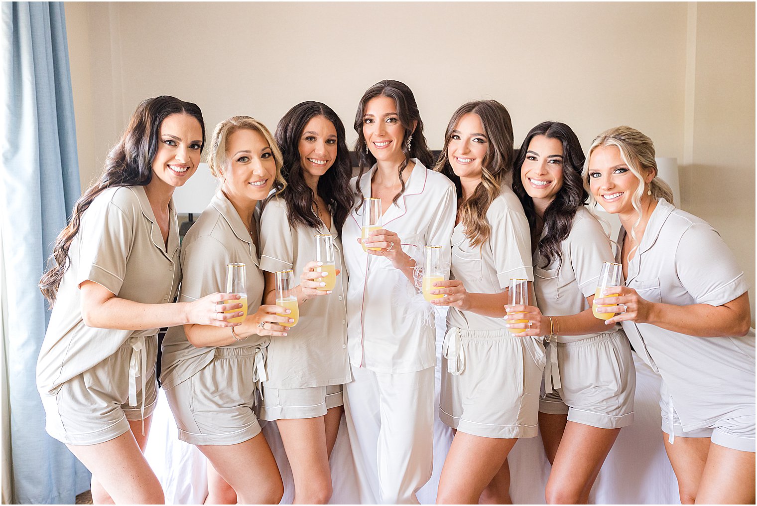 bride and bridesmaids pose in matching pajamas at The Mill Lakeside Manor