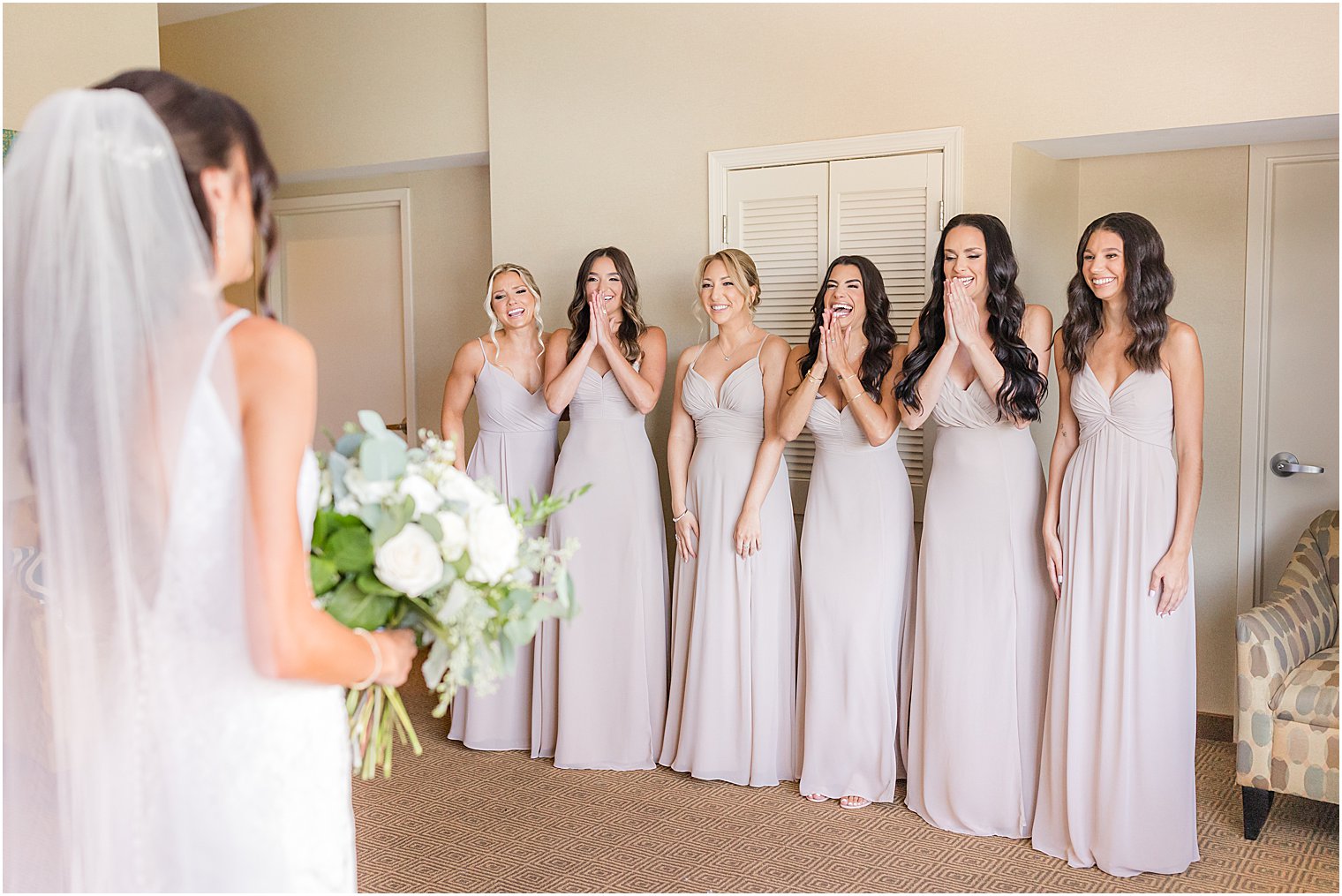bride has first look with bridesmaids at The Mill Lakeside Manor