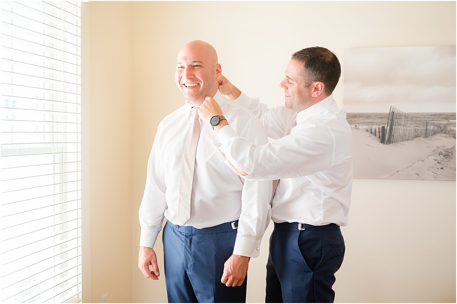 groomsman helps groom with prep for The Mill Lakeside Manor