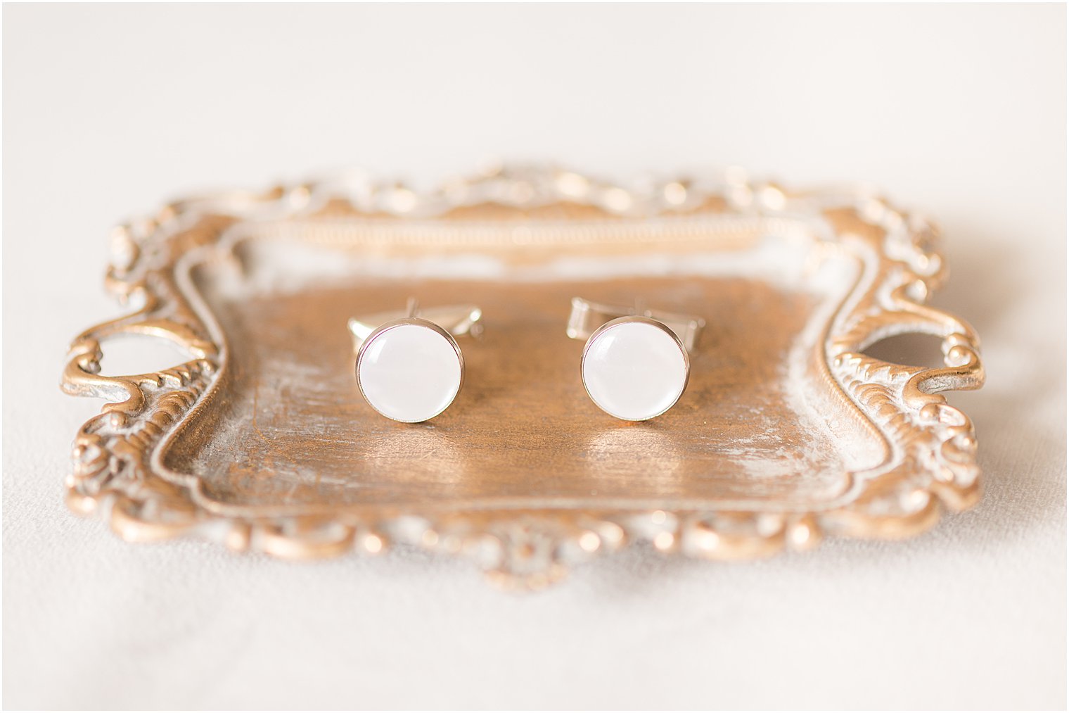 cufflinks on gold tray at The Mill Lakeside Manor