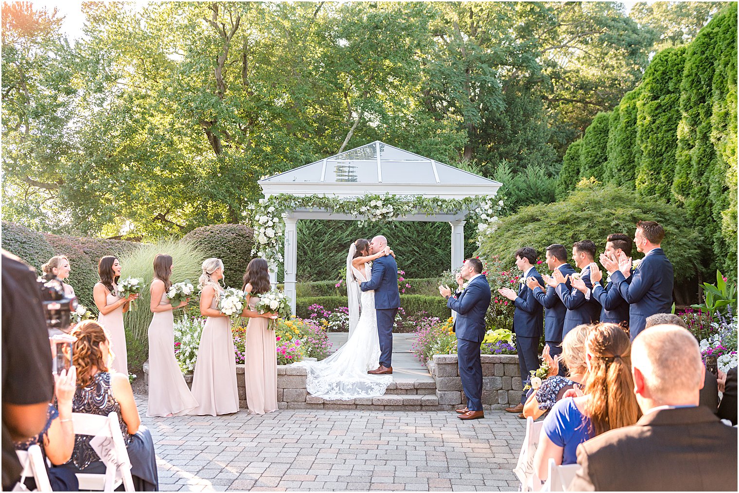 bride and groom kiss during garden wedding ceremony in New Jersey