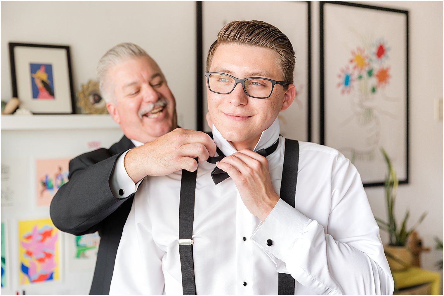 father adjusts bowtie for groom before The Mill Lakeside Manor wedding