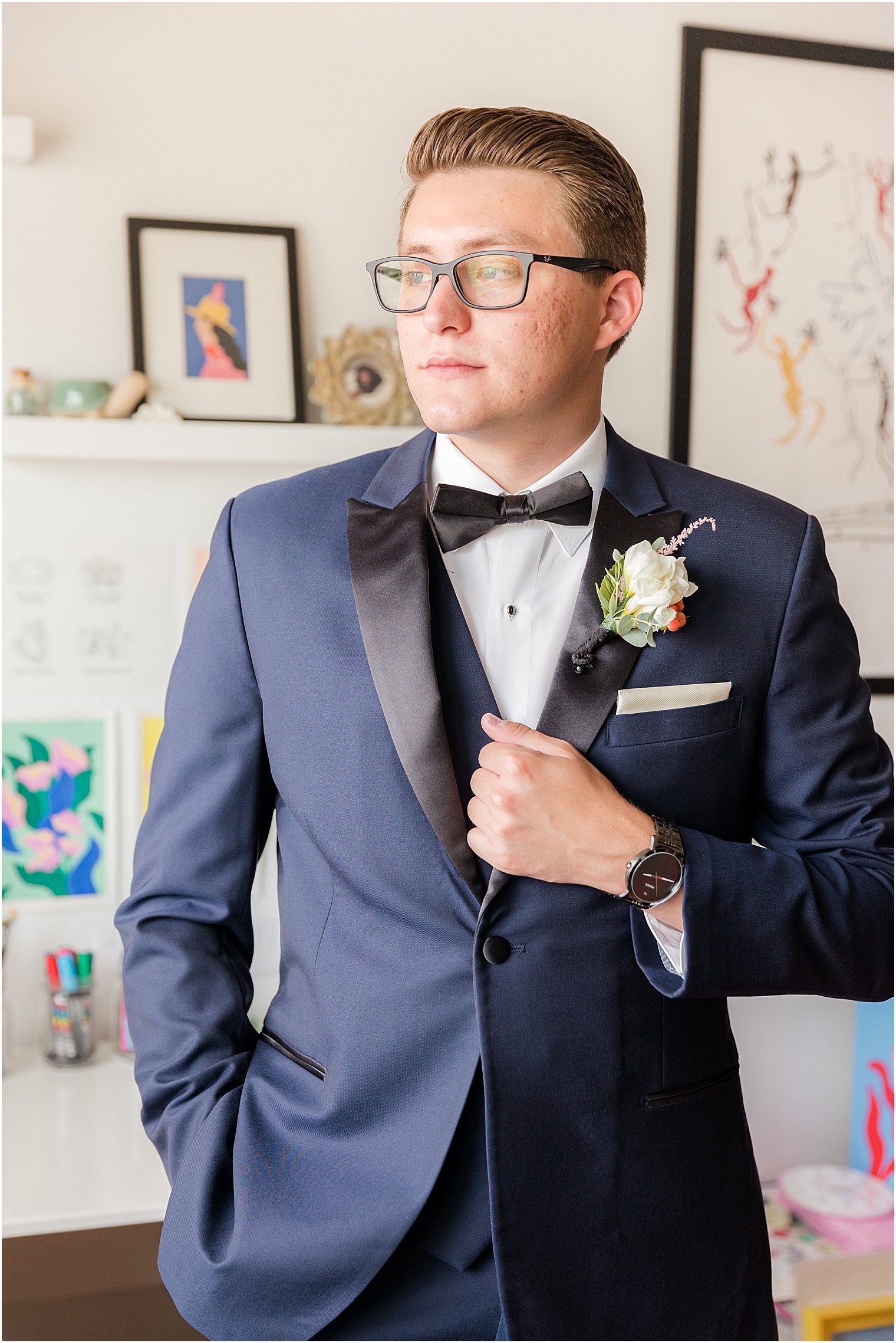 groom stands in navy jacket with black lapels before The Mill Lakeside Manor wedding