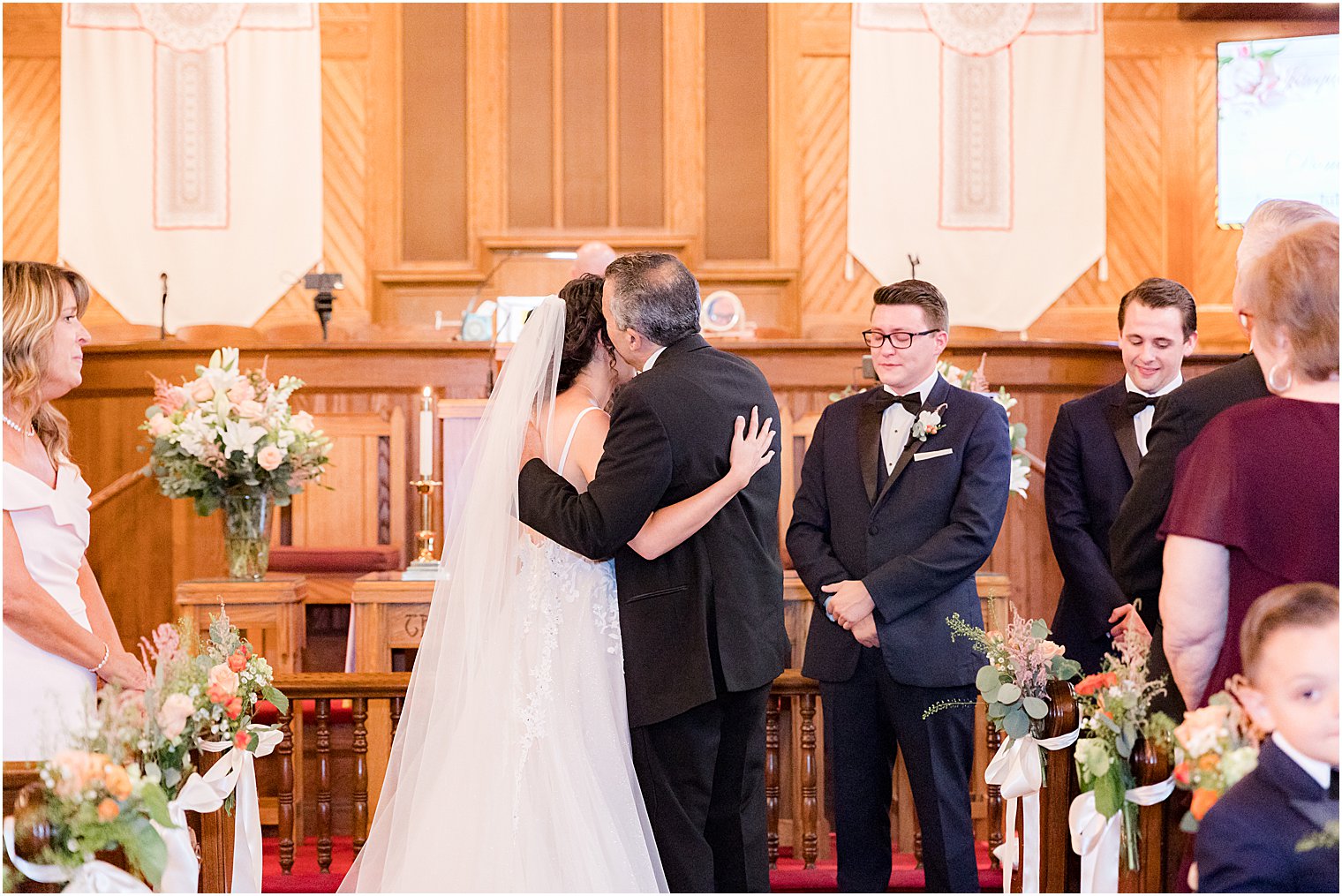 bride and dad hug during wedding ceremony at St. Andrew's United Methodist Church