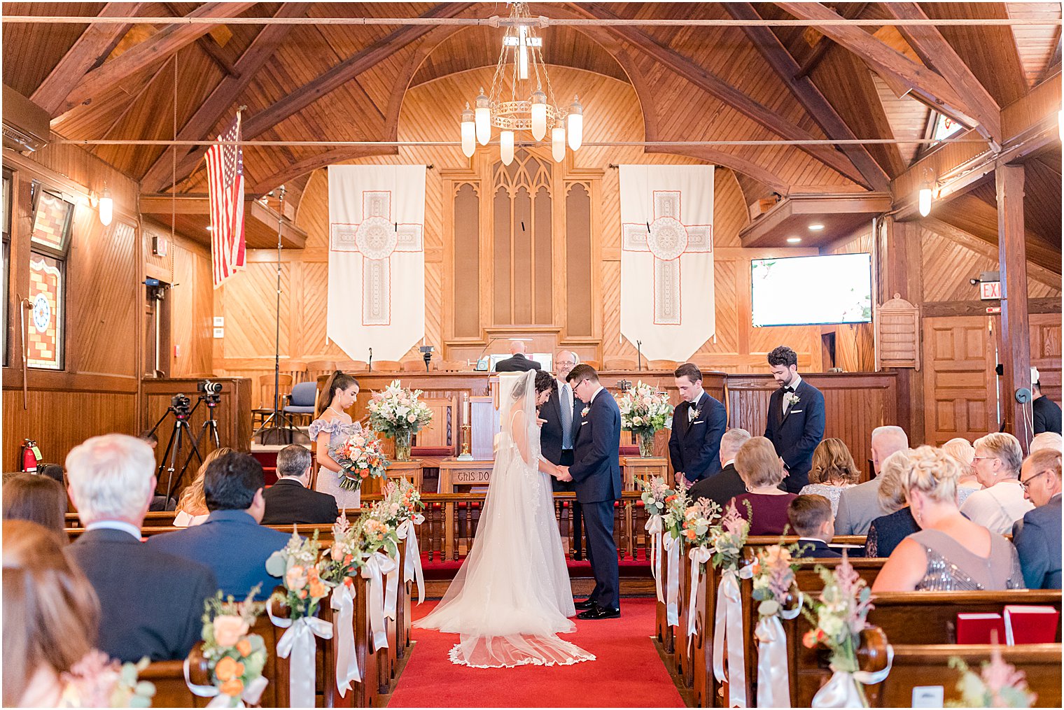 bride and groom hold hands during wedding ceremony at St. Andrew's United Methodist Church