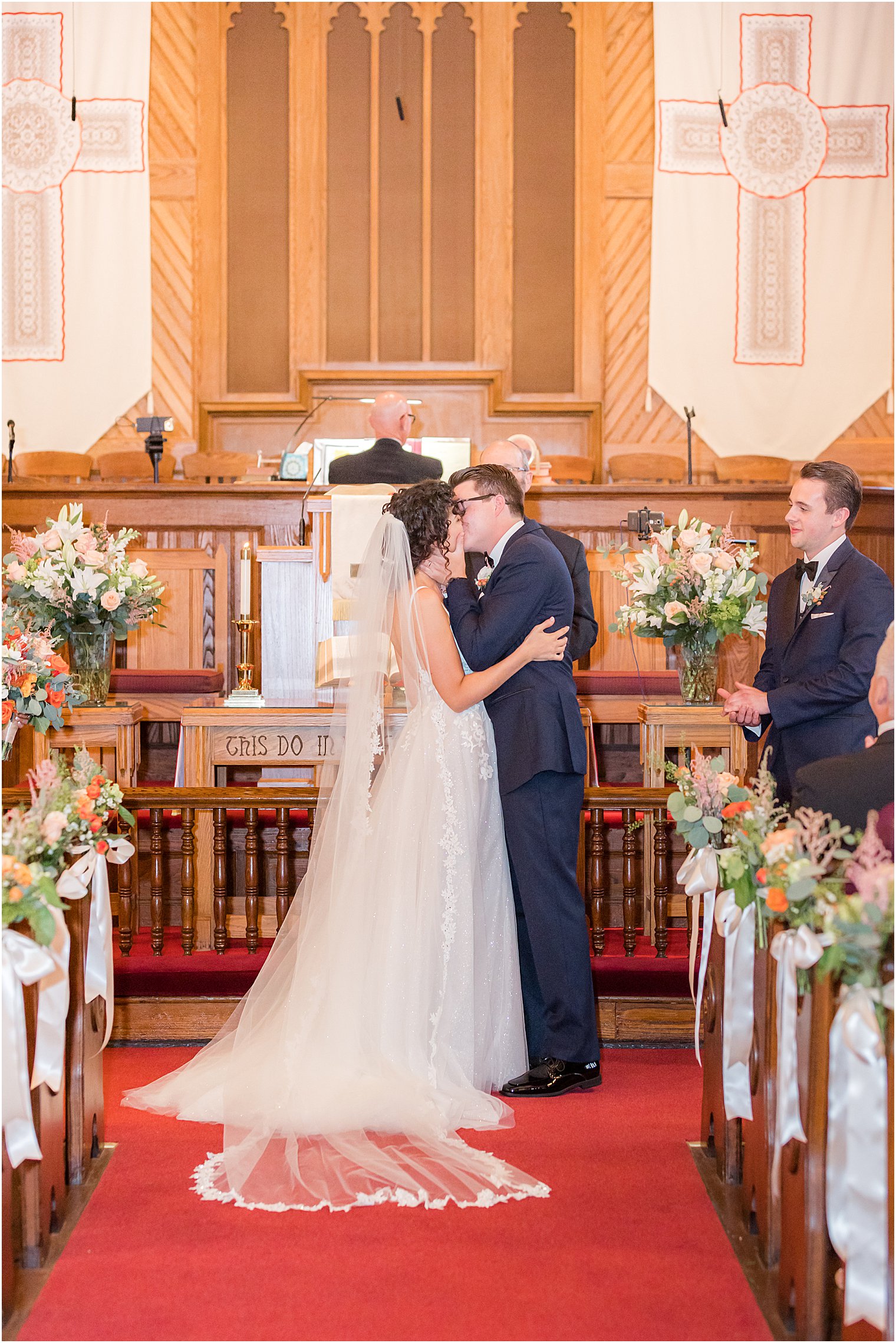 bride and groom kiss during wedding ceremony at St. Andrew's United Methodist Church