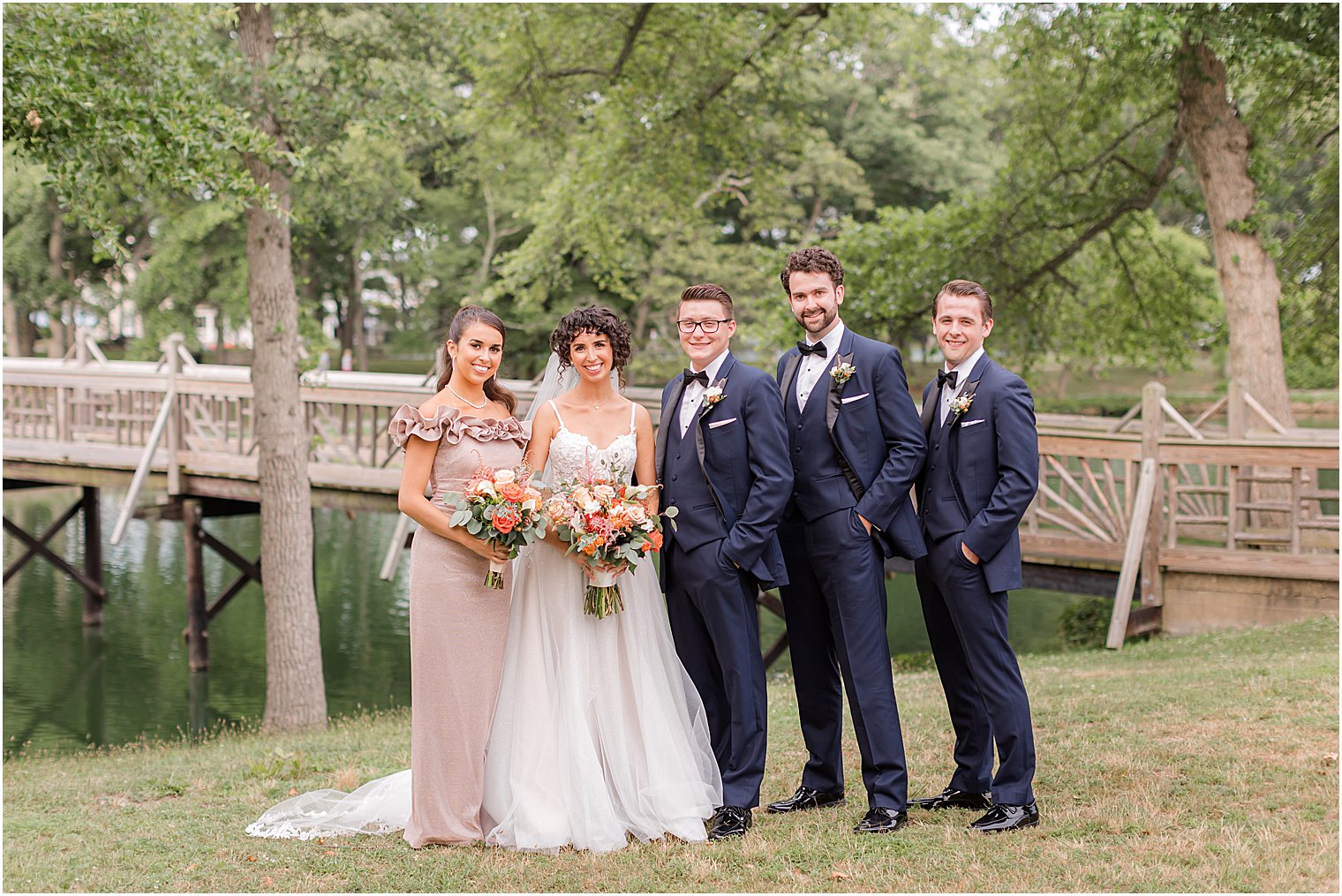 bride and groom pose with bridal party in Spring Lake Park