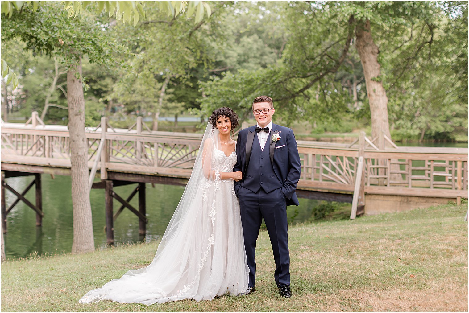 newlyweds stand together in New Jersey park 