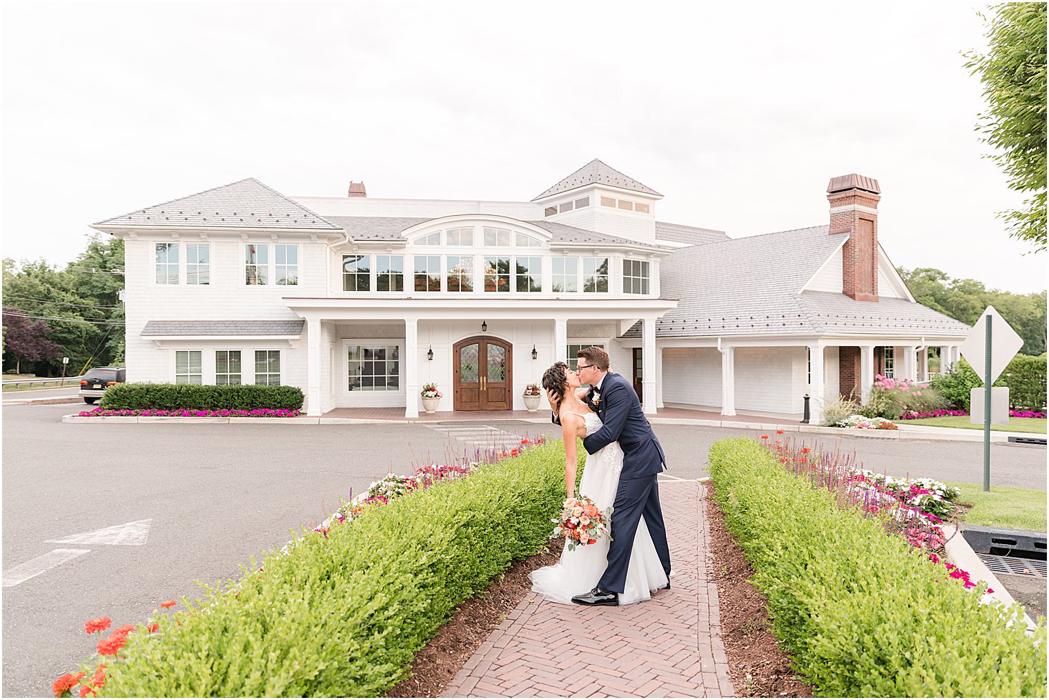 groom dips bride kissing her outside The Mill Lakeside Manor