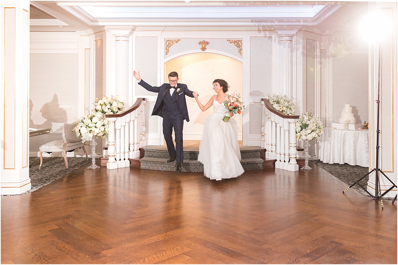 newlyweds enter ballroom for reception at The Mill Lakeside Manor
