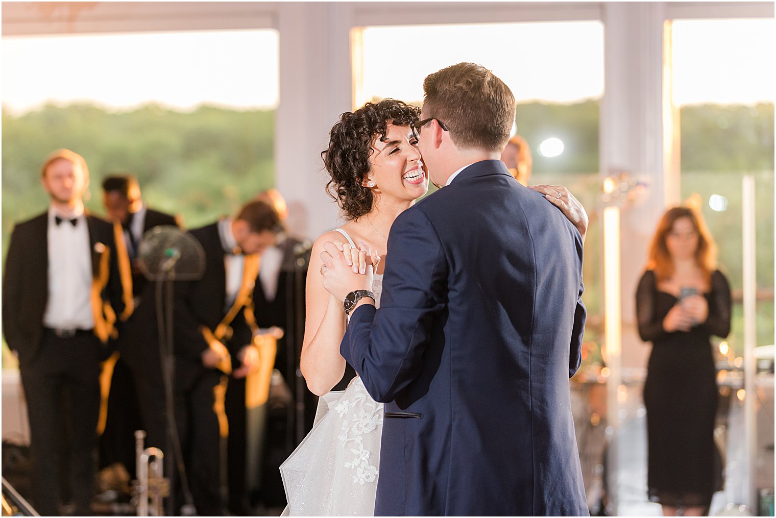 bride smiles at groom during first dance