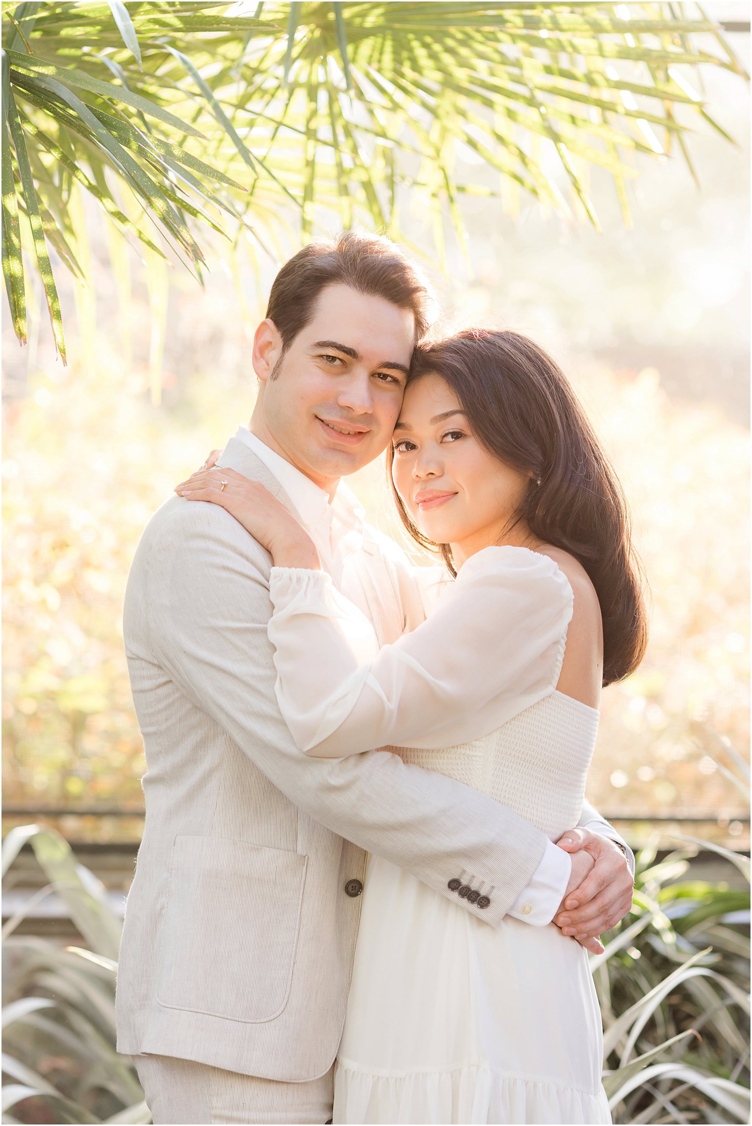 woman leans head into groom's cheek during proposal