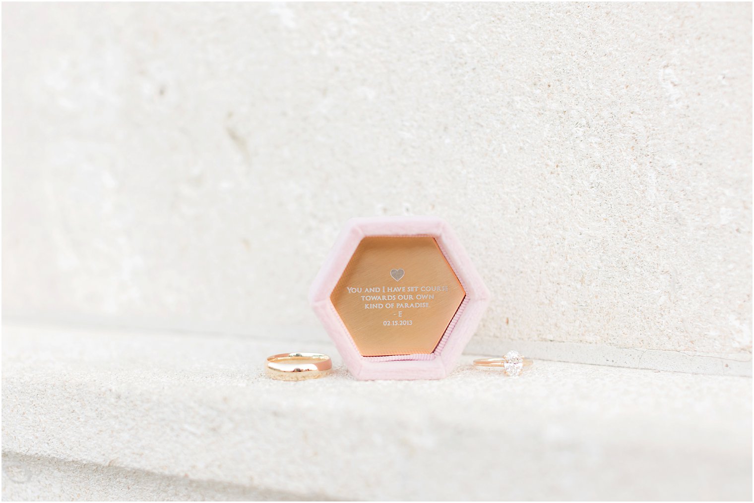 engagement ring rests by pink box with custom engraving