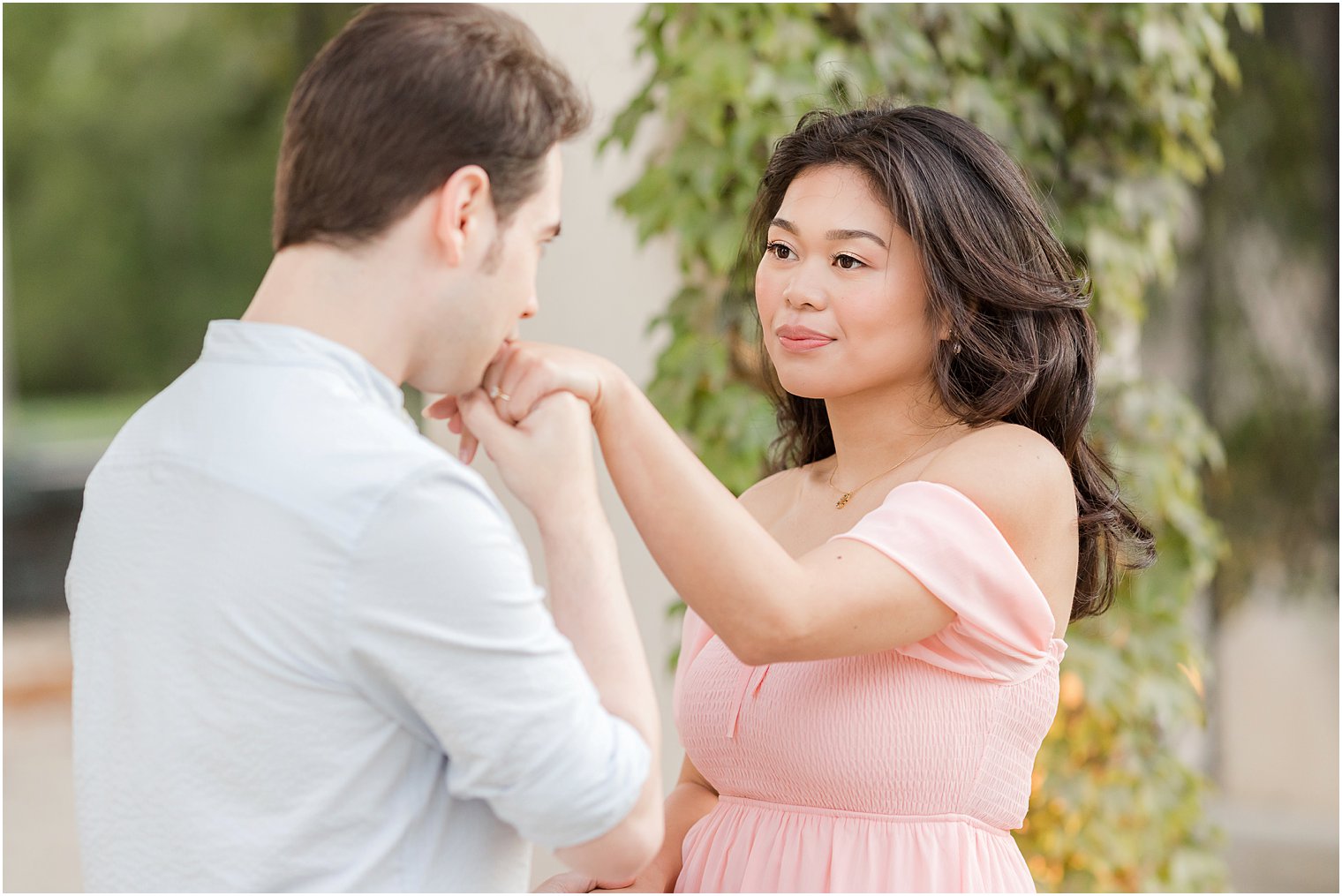 man kisses fiancee's ring at Longwood Gardens