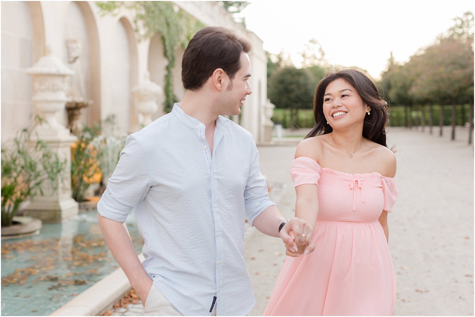 couple laughs walking through Longwood Gardens