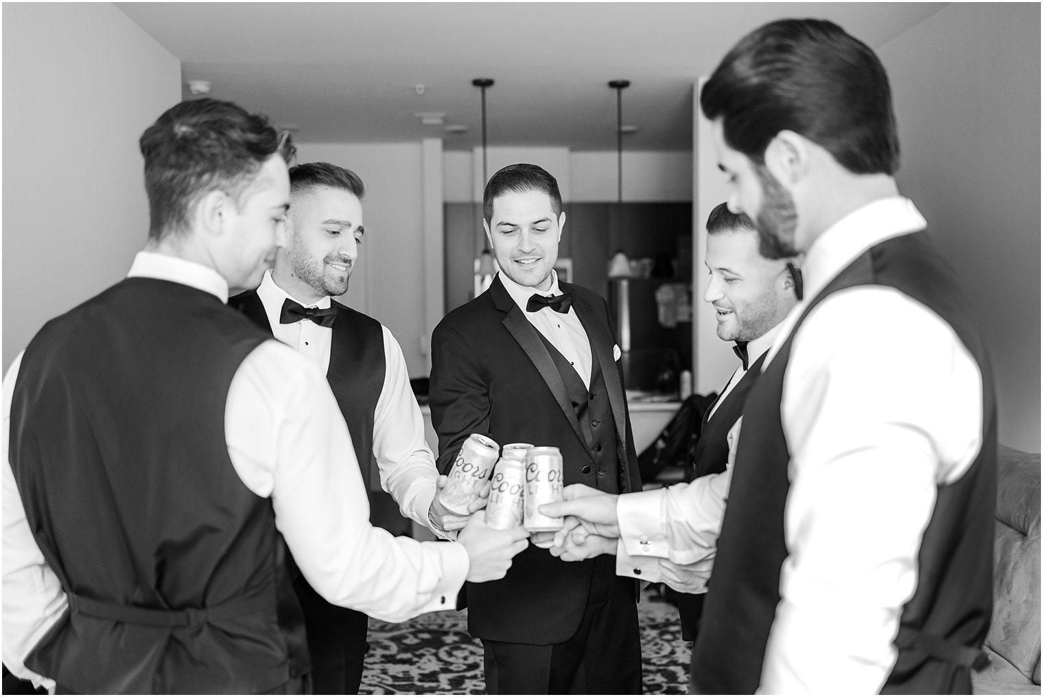 groom and groomsmen toast beers