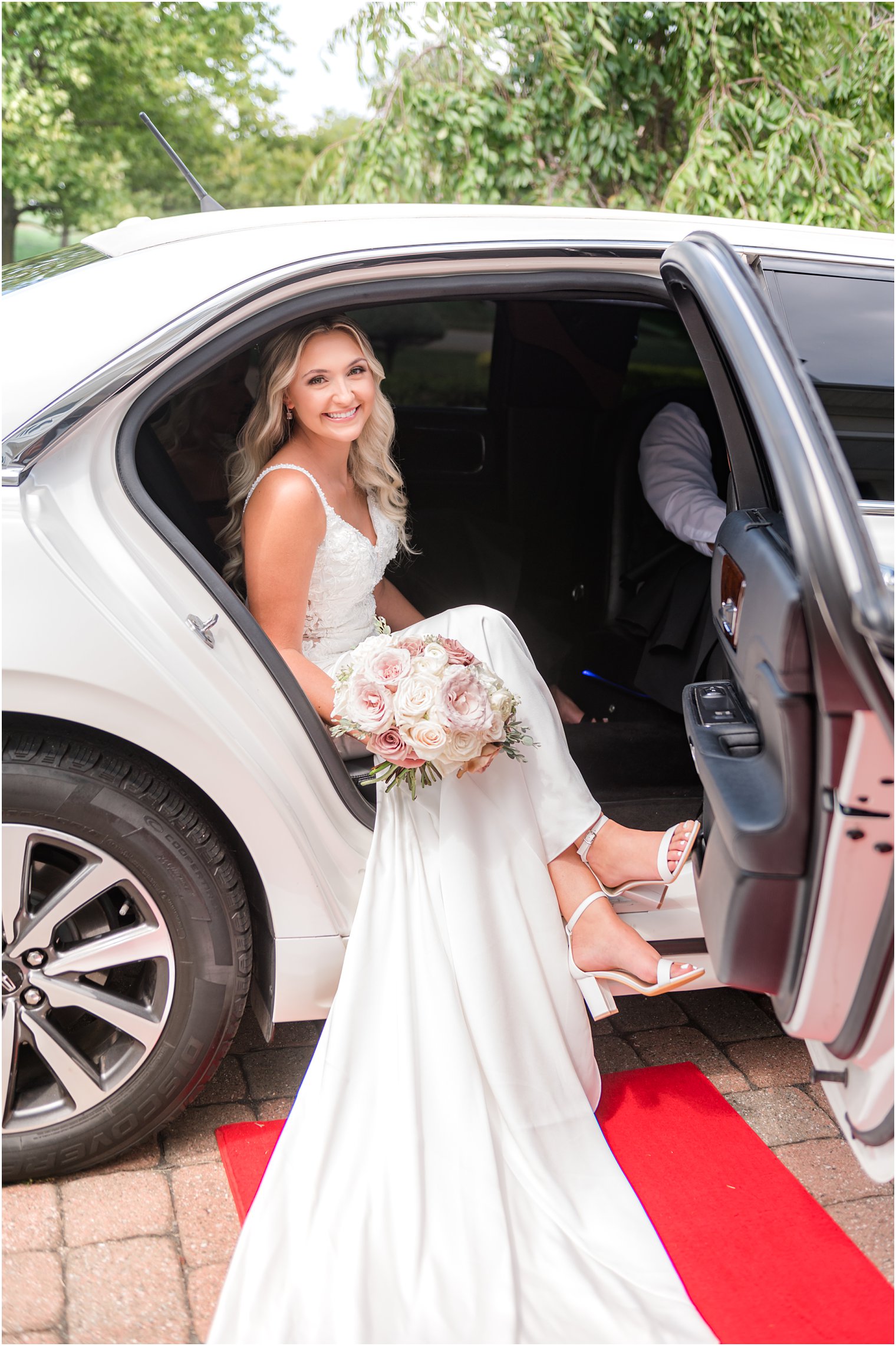 bride leaves classic car before wedding ceremony