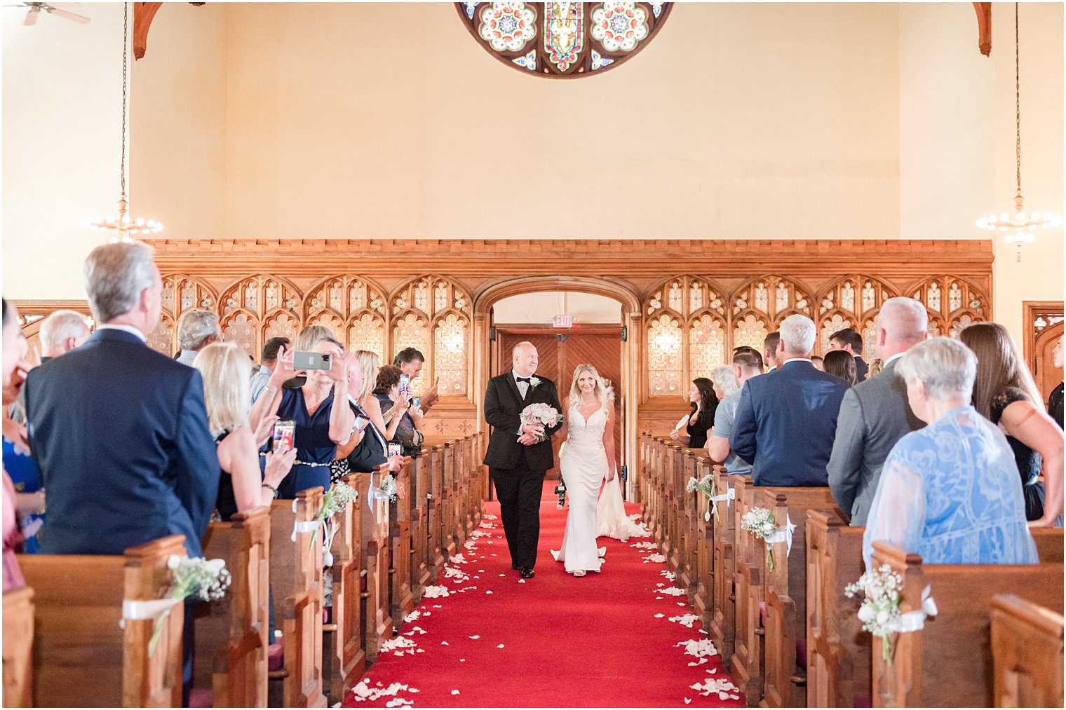 bride walks down aisle with father for traditional church wedding in New Jersey