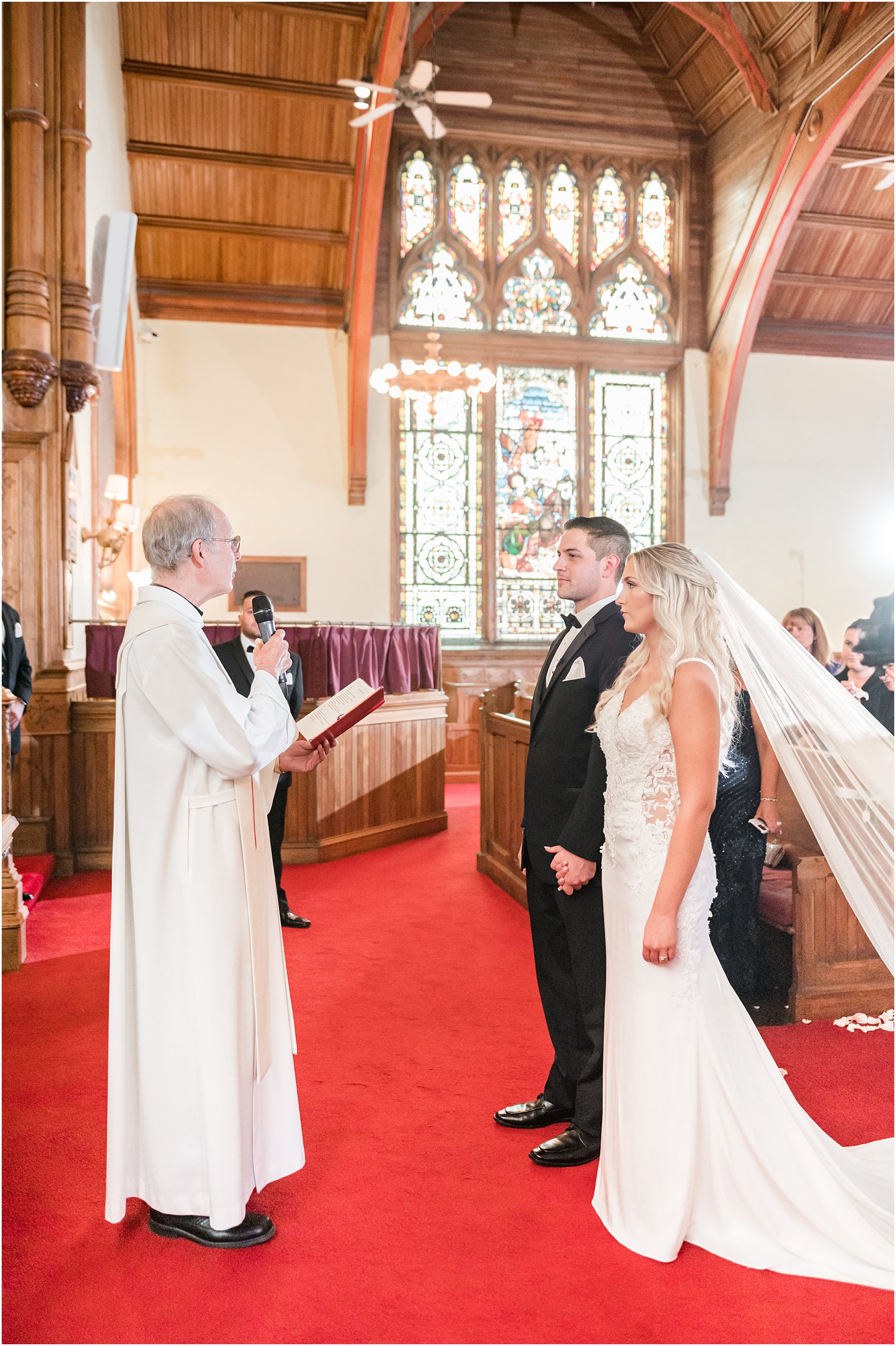 bride and groom stand together during traditional church wedding in New Jersey