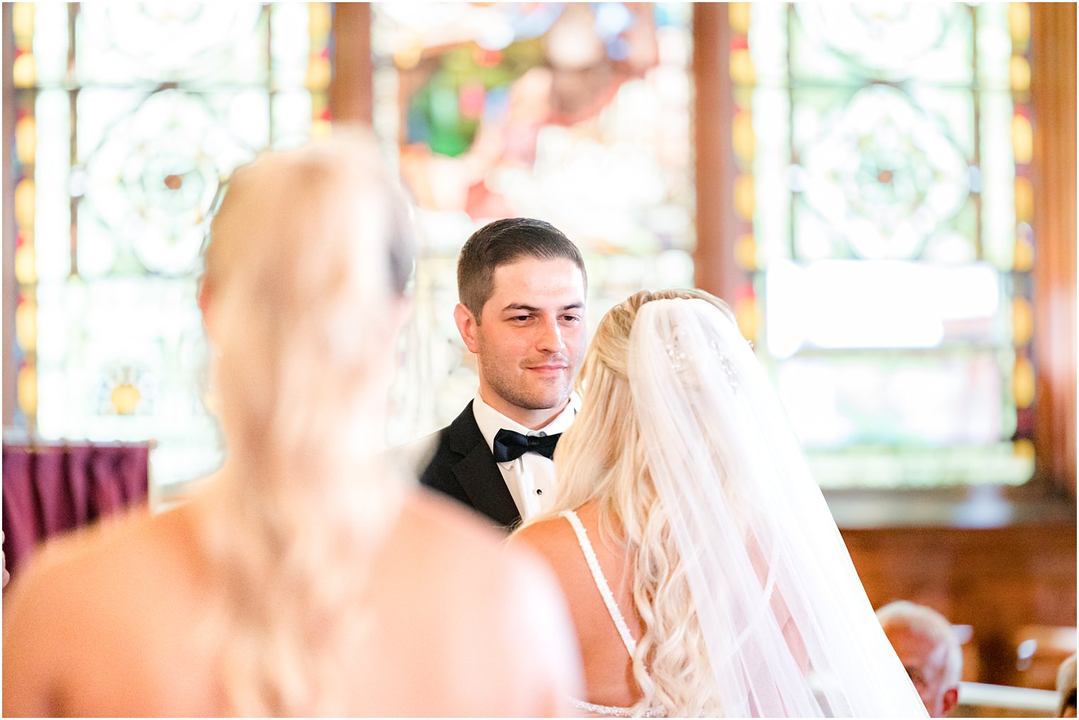 groom looks at bride during traditional church wedding in New Jersey