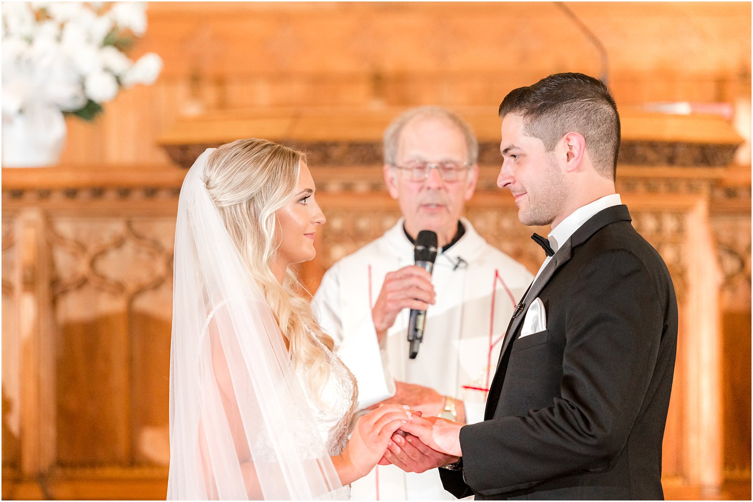 bride and groom recite vows during traditional church wedding in New Jersey