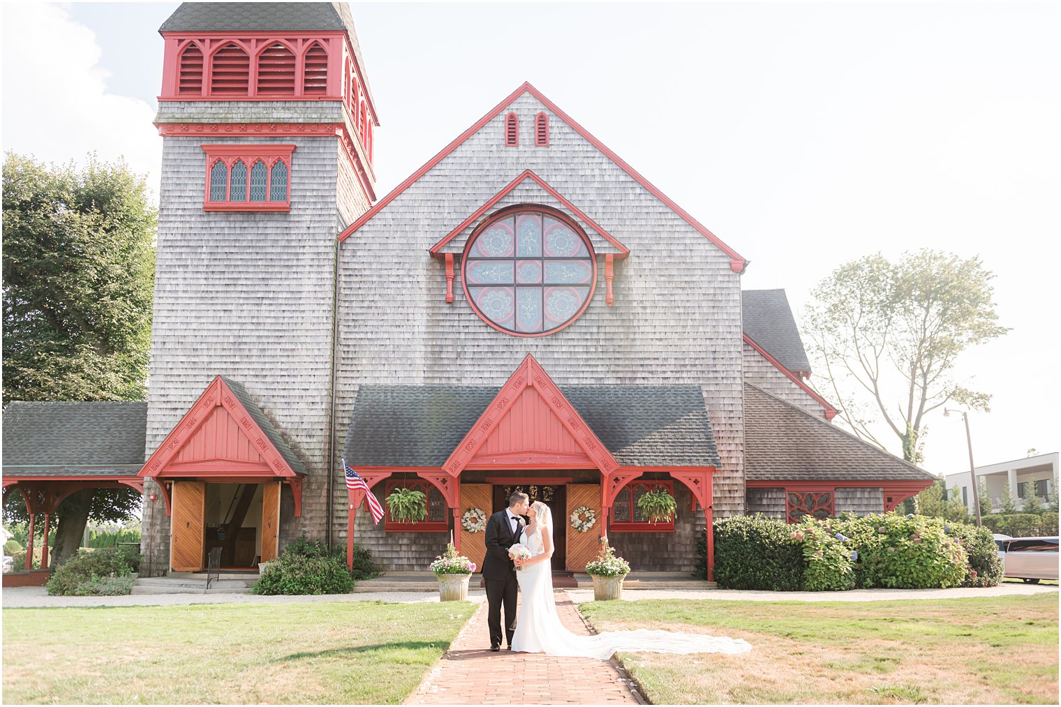 newlyweds kiss outside historic church in Ocean Township NJ