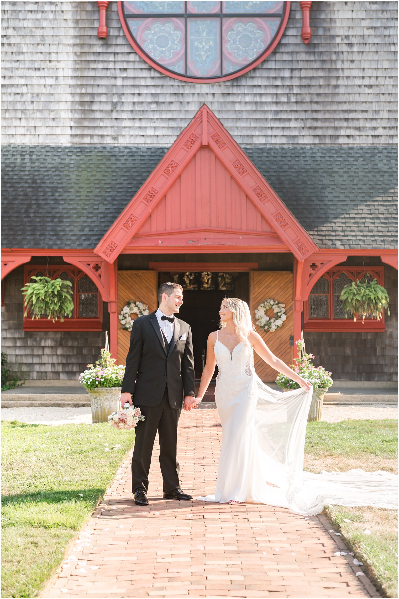 bride and groom stand outside church in New Jersey