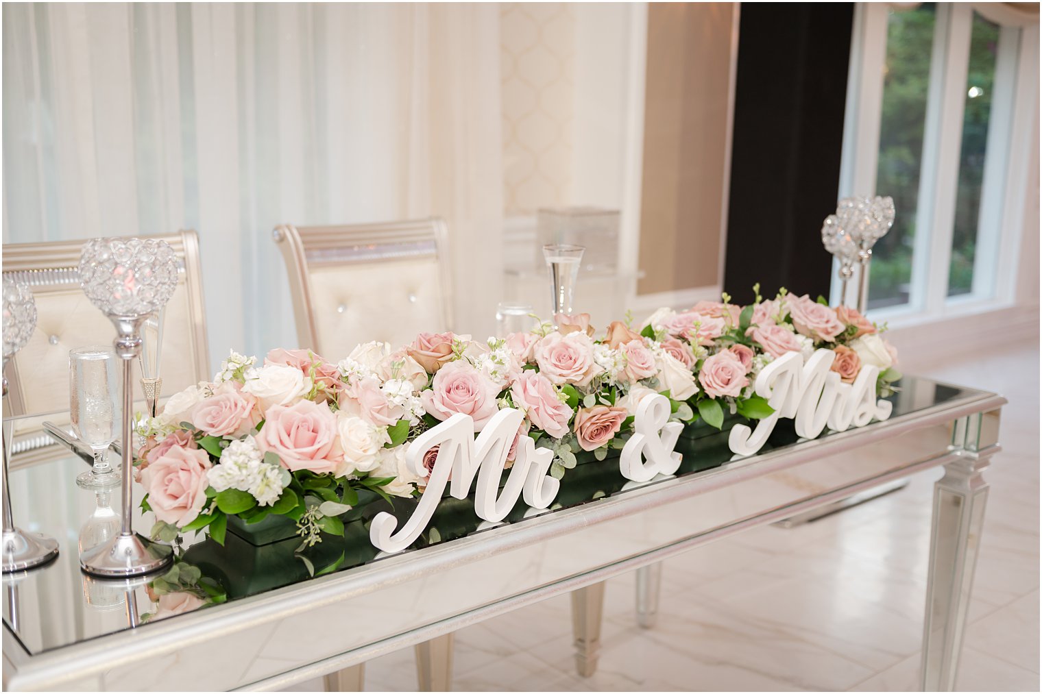 pink and white floral arrangement on sweetheart table at The English Manor