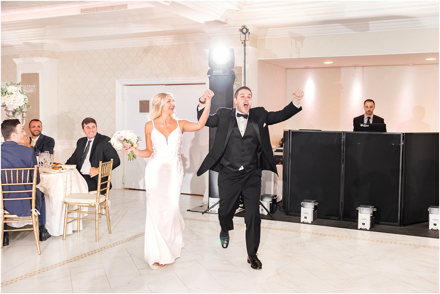 bride and groom cheer walking into NJ wedding reception