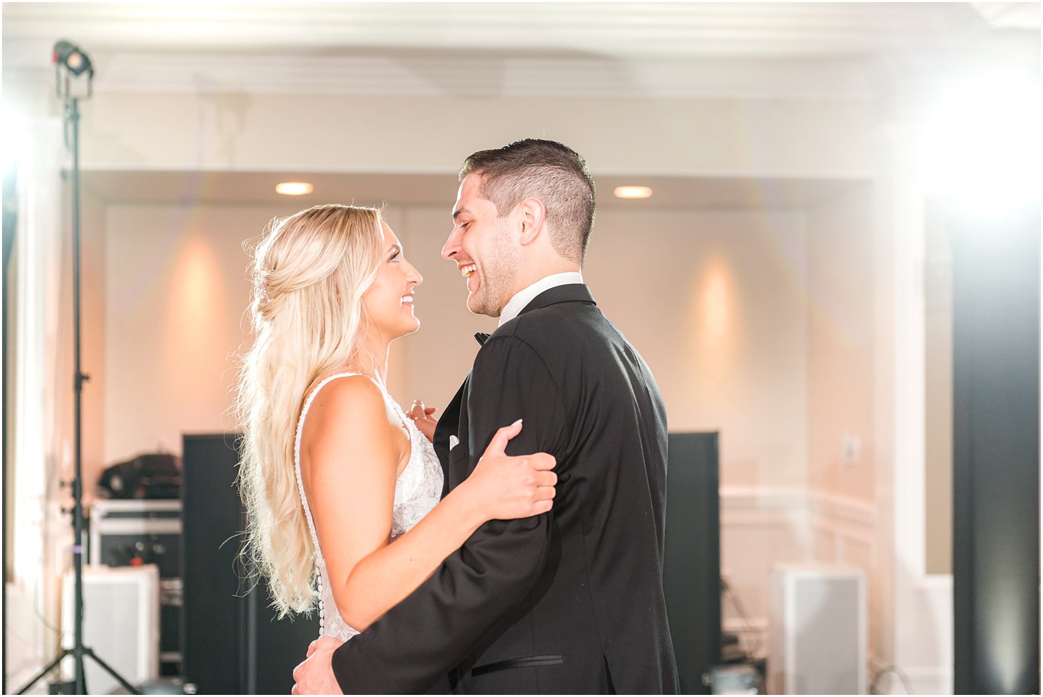 groom smiles at bride dancing at NJ wedding reception